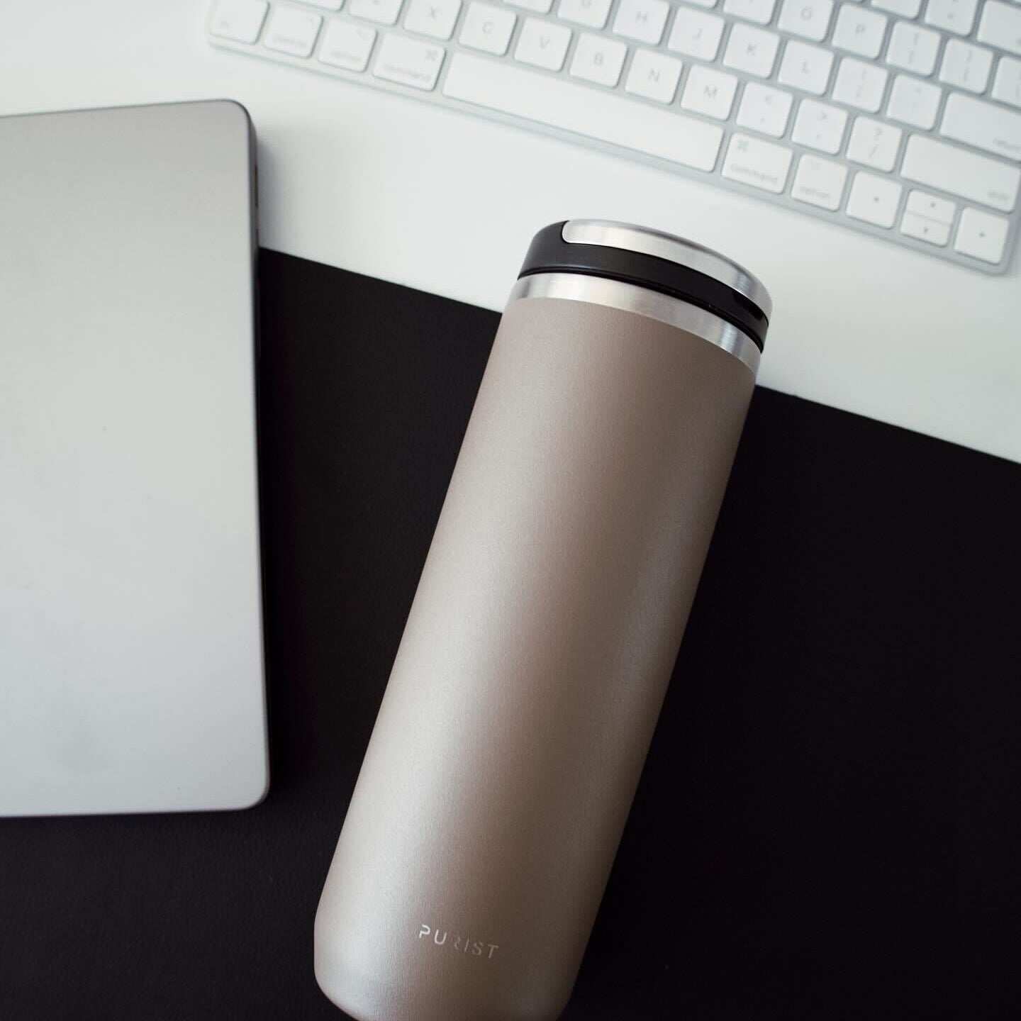 Photo of Purist Collective Mover  bottle in Clay with Element Lid on desk.
