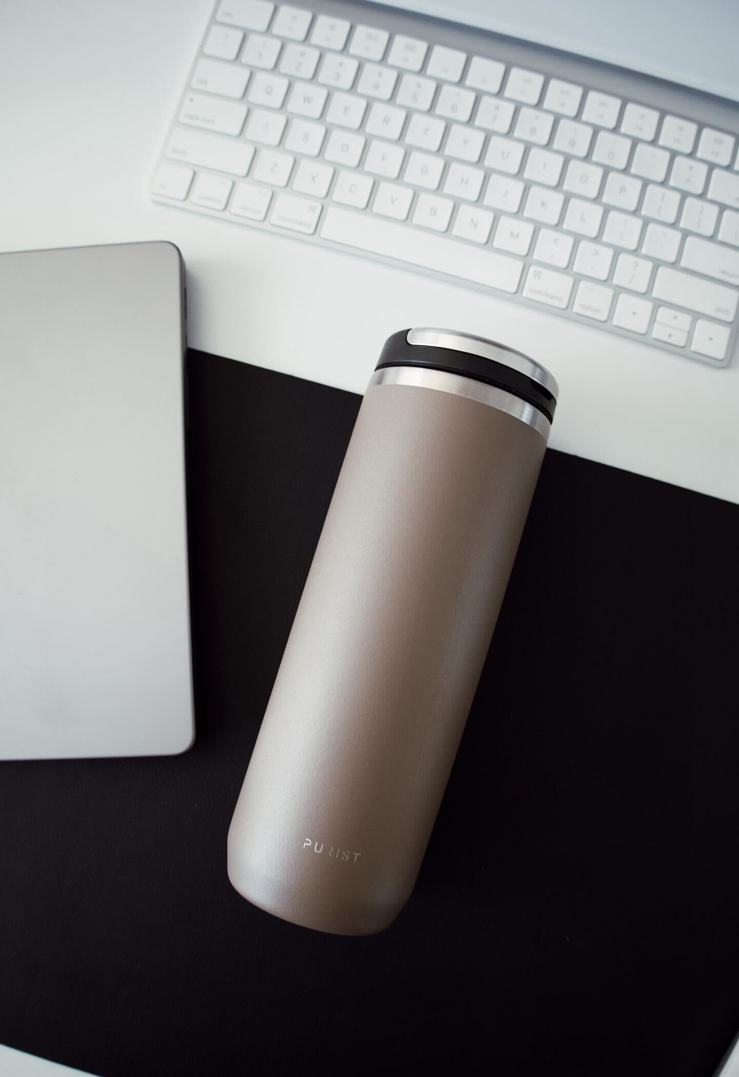 Photo of Purist Collective Mover  bottle in Clay with Element Lid on desk.