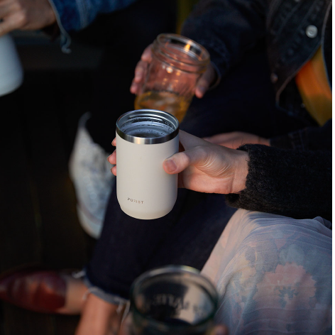 People gathered with different glasses with focus on 10oz Maker in Bone.