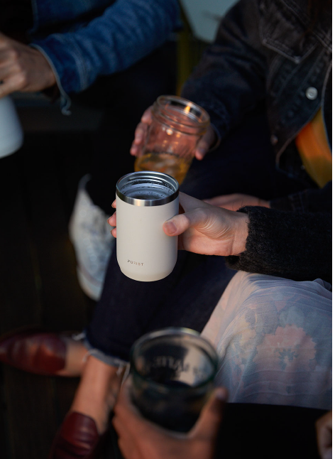 People gathered with different glasses with focus on 10oz Maker in Bone.
